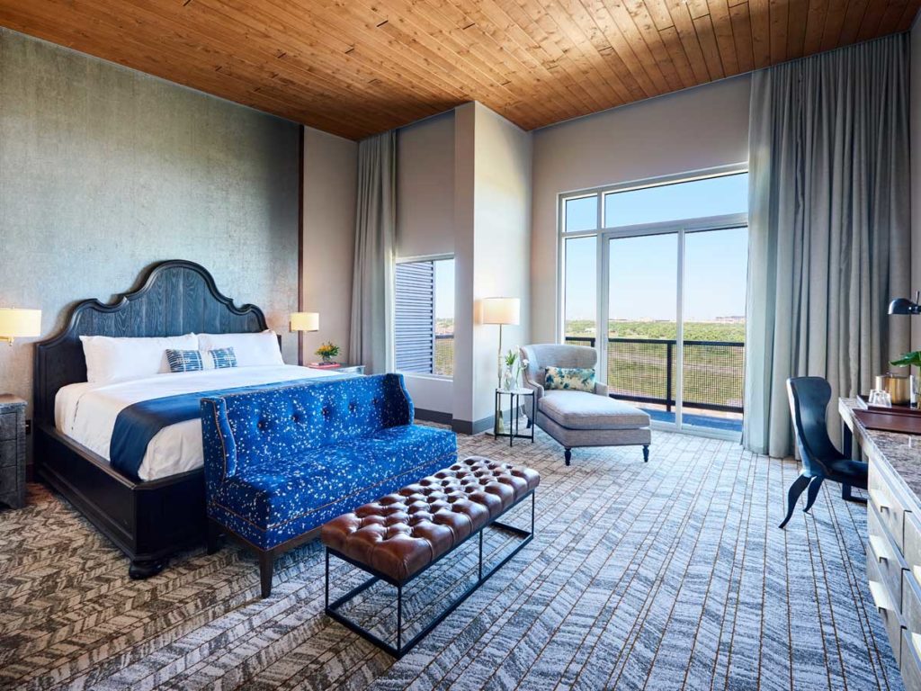 Spacious guestroom with a desk and sitting area.
